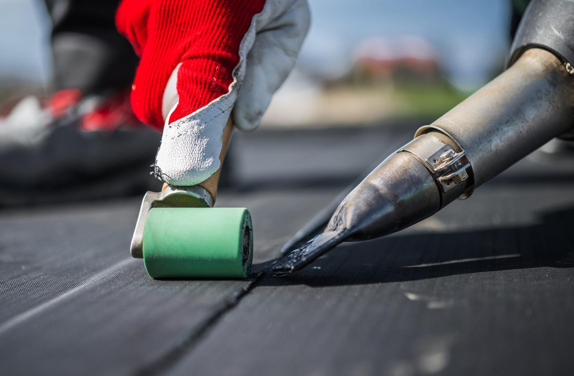 EDPM membrane roofing installation on flat roof