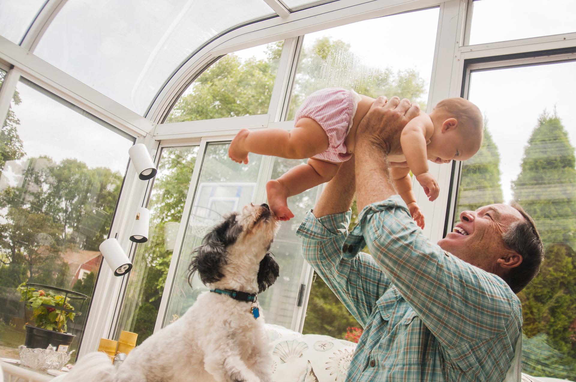 Family relaxing in a conservatory with a sound, leak-free roof